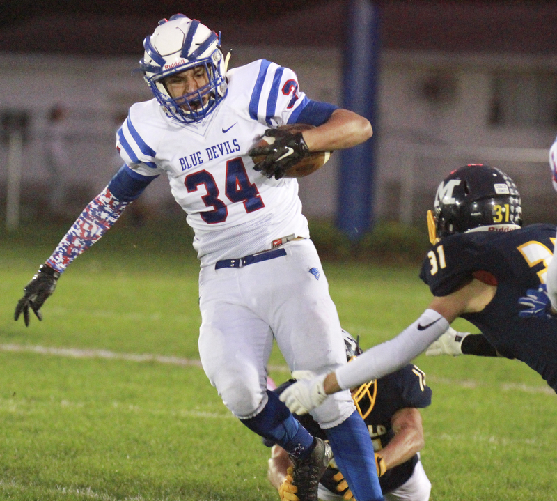 William D Lewis the Vindicator WR's Jack Cappabianca(34) eludes McDonald's Alex Cintron(31) during 1rst half action in McDonald 10-9-15.