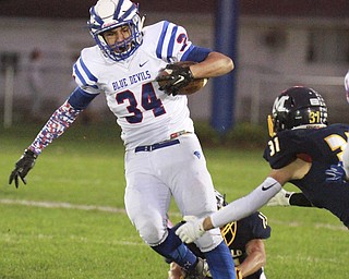 William D Lewis the Vindicator WR's Jack Cappabianca(34) eludes McDonald's Alex Cintron(31) during 1rst half action in McDonald 10-9-15.