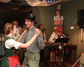 William D Lewis the Vindicator Auggie Heschmeyer and his sister D'Ella Heschmeyer of Liberty dance to German music at Kravitz Deli in Liberty Friday as part of Oktoberfest event.