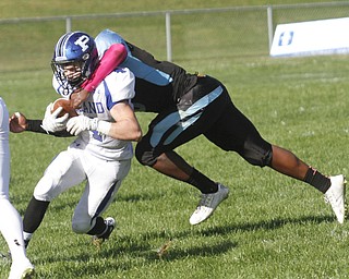        ROBERT K. YOSAY  | THE VINDICATOR..Poland at East - Dylan Garver gets neck hold tackled as he is pushed out of bounds by Tabrian Donlow