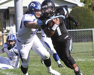        ROBERT K. YOSAY  | THE VINDICATOR..Poland at East -..East #1 Imoni Donadelle  eludes #49 Ethan Moncilovich for poland as he scampers out of the backfield  during second quarter action