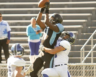        ROBERT K. YOSAY  | THE VINDICATOR..Poland at East -  #11 East pulls in a TD  as #1Dan Klase and and D#4 Dylan Garver defends  during second quarter action