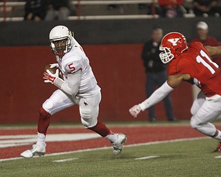        ROBERT K. YOSAY  | THE VINDICATOR..Redbirds QB #5  Tre Roberson is chased  out of the pocket by #11 Derek Rivers.   Tre was forced to throw a pass out of bounds