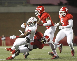        ROBERT K. YOSAY  | THE VINDICATOR..Redbirds #25 Marshaun Coprich is brought down after a first in 10 by YSU #7 Tanner Gary and #3 Leroy Alexander adn#5 Demond Hymes