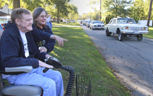 Wiliam d Lewis the vindicator Dennis Hake is all smiles as he and his wife Dolly watch a parade of classic cars passing their Howland home 10-11-15. Hake , a car enthusiast is suffering form serious illnes and his wish was to see a car show.