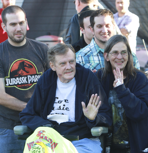 Wiliam d Lewis the vindicator Dennis Hake is all smiles as he and his wife Dolly watch a parade of classic cars passing their Howland home 10-11-15. Behind them are his sons Joshua, left, and Waid. Hake , a car enthusiast is suffering form serious illnes and his wish was to see a car show.