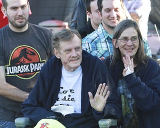 Wiliam d Lewis the vindicator Dennis Hake is all smiles as he and his wife Dolly watch a parade of classic cars passing their Howland home 10-11-15. Behind them are his sons Joshua, left, and Waid. Hake , a car enthusiast is suffering form serious illnes and his wish was to see a car show.