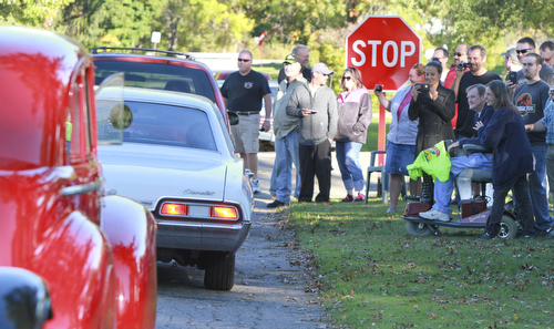 Wiliam d Lewis the vindicator Dennis Hake is all smiles as he and his wife Dolly and a large group of onlookers watch a parade of classic cars passing their Howland home 10-11-15. Hake , a car enthusiast is suffering form serious illnes and his wish was to see a car show.