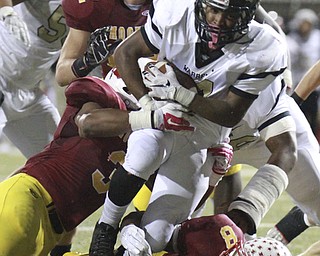 William D. Lewis The Vindicator  HArding's Isaiah Wells (24) is stopped by a host of Mooney defenders during 1rst half action 10-15-15 at Stambaugh.
