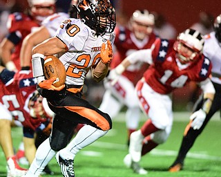 NILES, OHIO - OCTOBER 15, 2015: Victor Williams #20 of Howland runs the football for a big gain during the 1st half of a game at Niles High School on Thursday night. DAVID DERMER | THE VINDICATOR