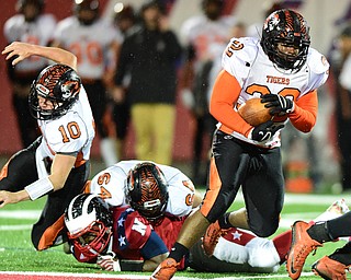 NILES, OHIO - OCTOBER 15, 2015: Isom Julian #32 of Howland runs the football after picking up a block from Zach Nites #64 on Damion Coleman #53 of Niles during the 1st half of a game at Niles High School on Thursday night. DAVID DERMER | THE VINDICATOR