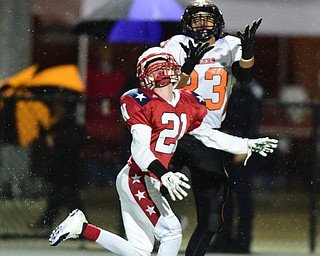 NILES, OHIO - OCTOBER 15, 2015: Steve Baugh #23 of Howland catches the football in stride over Bruce Guy #21 of Niles before running into the end zone to score a touchdown during the 1st half of a game at Niles High School on Thursday night. DAVID DERMER | THE VINDICATOR