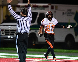 NILES, OHIO - OCTOBER 15, 2015: Steve Baugh #23 of Howland celebrates after scoring on a touchdown reception during the 1st half of a game at Niles High School on Thursday night. DAVID DERMER | THE VINDICATOR