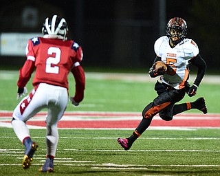 NILES, OHIO - OCTOBER 15, 2015: Tyriq Ellis #5 of Howland runs the football around the edge before Marlon Pearson #2 of Niles can break down and make a play during the 1st half of a game at Niles High School on Thursday night. DAVID DERMER | THE VINDICATOR