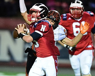 NILES, OHIO - OCTOBER 15, 2015: Tyler Srbinovich #13 of Niles fumbles the football while being sacked by Victor Williams #20 of Howland during the 1st half of a game at Niles High School on Thursday night. DAVID DERMER | THE VINDICATOR