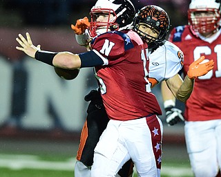 NILES, OHIO - OCTOBER 15, 2015: Tyler Srbinovich #13 of Niles fumbles the football while being sacked by Victor Williams #20 of Howland during the 1st half of a game at Niles High School on Thursday night. DAVID DERMER | THE VINDICATOR