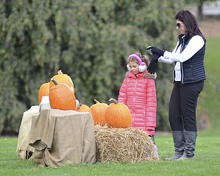 Katie Rickman | The Vindicator.Melina  (OKAY) Orr Orr of Howland and her daughter Gabriella look at Disney themed carved pumpkins on display during the 12th Annual Pumpkin Walk at Twilight at Fellows Riverside Gardens Sunday evening.