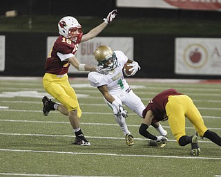        ROBERT K. YOSAY  | THE VINDICATOR..First quarter action as Ursulines #1 Daylen Harris  Gets stopped after a first down by Mooneys #18 Patrick Pelini and #21  Justin Lanzo.....Ursuline vs Mooney at Stambaugh Stadium...-30-