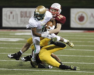        ROBERT K. YOSAY  | THE VINDICATOR..First quarter action as Ursulines #1 Daylen Harris  Gets stopped after a first down by Mooneys #18 Patrick Pelini and #21  Justin Lanzo.....Ursuline vs Mooney at Stambaugh Stadium...-30-