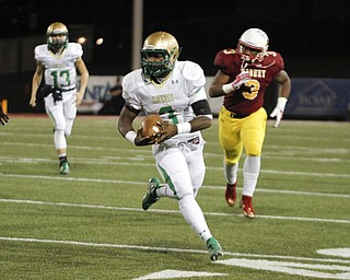        ROBERT K. YOSAY  | THE VINDICATOR..First quarter action as Ursulines 3 Kimauni Johnson makes a break around end and runs for 60+ yards  #3 DeVon McNutt and #13 Ursuline  Jared Fabry ..Ursuline vs Mooney at Stambaugh Stadium...-30-
