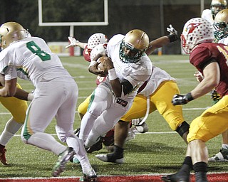        ROBERT K. YOSAY  | THE VINDICATOR..Ursulines #3  Kimauni Johnson breaks through the line for a score as Blocker #8  Deion Edwards and Mooneys #12  andrew Armstrong watch..Ursuline vs Mooney at Stambaugh Stadium...-30-