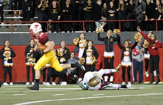        ROBERT K. YOSAY  | THE VINDICATOR..Mooneys #12 Andrew Armstrong goes for a quick 6 as Ursulines #11 Marcus Mosley falls to the ground after a quick pass during second quarter..Ursuline vs Mooney at Stambaugh Stadium...-30-