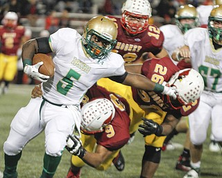        ROBERT K. YOSAY  | THE VINDICATOR..Ursulines #5 Ty Spinks runs hard as moonesy #9 David McDowell  and #26  Andrew McCoy  fight to bring him down #12 is Andrew Armstrong..Ursuline vs Mooney at Stambaugh Stadium...-30-