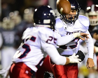BOARDMAN, OHIO - OCTOBER 23, 2015: Ben Nishimura #13 options the ball to Randy Smith #25 of Fitch during the 1st half of their game Friday night at Boardman High School. DAVID DERMER | THE VINDICATOR