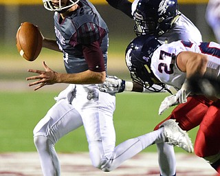 BOARDMAN, OHIO - OCTOBER 23, 2015: J.R. Ryan #17 of Boardman is sacked from behind by Darrell Jackson #11 of Fitch and Zach Krohn #27 during the 1st half of their game Friday night at Boardman High School. DAVID DERMER | THE VINDICATOR