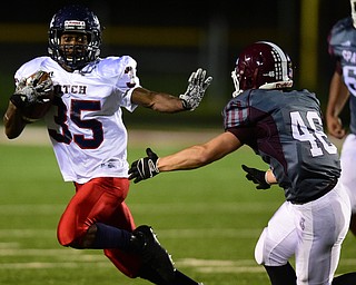 BOARDMAN, OHIO - OCTOBER 23, 2015: Marquis Barbel #35 of Fitch prepares to stiff arm Mike Melewski #46 of Boardman during the 1st half of their game Friday night at Boardman High School. DAVID DERMER | THE VINDICATOR
