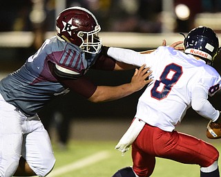 BOARDMAN, OHIO - OCTOBER 23, 2015: Nate Fowler #8 of fifth is dragged down for a sack by Wes Thompson #66 of Boardman during the 1st half of their game Friday night at Boardman High School. DAVID DERMER | THE VINDICATOR