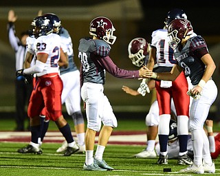 BOARDMAN, OHIO - OCTOBER 23, 2015: Adam Deeley #38 of Boardman is congratulated by Alex Duda #8 after a successful field goal during the 1st half of their game Friday night at Boardman High School. DAVID DERMER | THE VINDICATOR