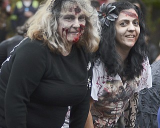 Katie Rickman | The Vindicator.Neighbors Karen Zagorsky on left and Maddalena Gillen both of Struthers dance to Thriller by Michael Jackson during the fifth annual Zombie Crawl at the B&O in Youngstown on Saturday evening. At about 6:45 the "zombies" walked over the Spring Commons Bridge to walk down Federal Street.
