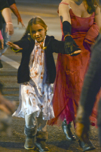 Katie Rickman | The Vindicator.Felicia Mentzer 7 of Poland acts the part of a zombie as she crosses the road after stumbling over the Spring Commons Bridge during the fifth annual Zombie Crawl at the B&O in Youngstown on Saturday evening.