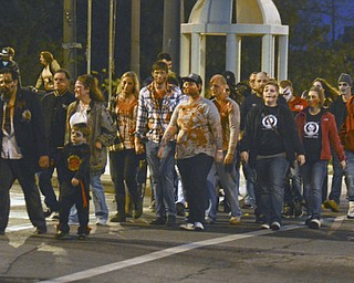 Katie Rickman | The Vindicator.Zombies choose the safe route and cross the street after walking over the  Spring Commons Bridge during the fifth annual Zombie Crawl at the B&O in Youngstown on Saturday evening.
