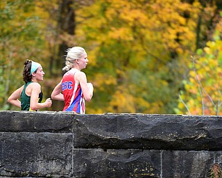 YOUNGSTOWN, OHIO - OCTOBER 25, 2015: Megan Gibson (white) and Renee Harden (green) jog along West Glacier Drive inside Mill Creek Park during the Peace Race Sunday morning. DAVID DERMER | THE VINDICATOR