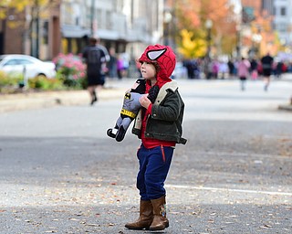 YOUNGSTOWN, OHIO - OCTOBER 25, 2015: Owen Papini 4, of Boardman holds his Batman toy while dressed up as Spider-Man while  watching runners jog toward the finish line along West Federal Street during the Peace Race Sunday morning. DAVID DERMER | THE VINDICATOR