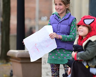 YOUNGSTOWN, OHIO - OCTOBER 25, 2015: Lucy Papini 8, of Boardman smiles as her mom passes by her toward the finish line on West Federal Street during the Peace Race Sunday morning. DAVID DERMER | THE VINDICATOR