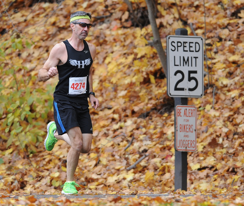 YOUNGSTOWN, OHIO - OCTOBER 25, 2015: Gary Ford of Youngstown jogs along West Glacier Drive inside Mill Creek Park during the Peace Race Sunday morning. DAVID DERMER | THE VINDICATOR