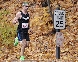 YOUNGSTOWN, OHIO - OCTOBER 25, 2015: Gary Ford of Youngstown jogs along West Glacier Drive inside Mill Creek Park during the Peace Race Sunday morning. DAVID DERMER | THE VINDICATOR