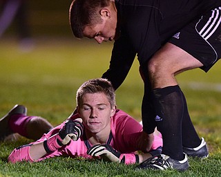 NORTH LIMA, OHIO - OCTOBER 27, 2015: Scott Murray #00 of Crestview is helped up by teammate Clayton Elliott #12 moments after South Range scored the first goal of the game during the 1st half of a game Tuesday night at the old South Range High School. DAVID DERMER | THE VINDICATOR