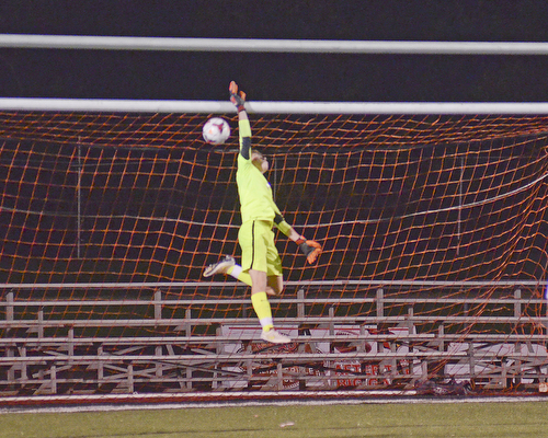 Katie Rickman | The Vindicator.Mooney's goal keeper Dustin Hudak (#1) blocks a goal with one hand and pushes it over the net during the first half of the game at Canfield High School on Wednesday, October 28, 2015.