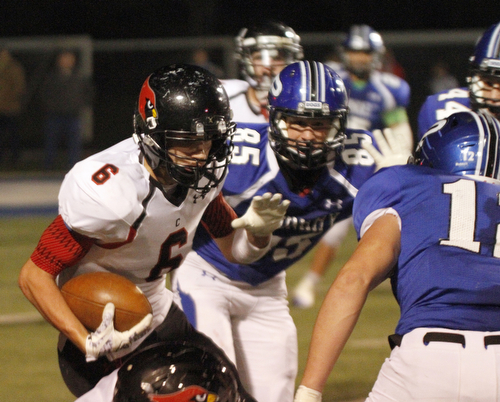       .         ROBERT  K. YOSAY | THE VINDICATOR..Canfields #6 Michael Rusu picks his way through the line as Polands #12 Tyler Smith and #85 Nick Miller give chase during second quarter action..Canfield at Poland Canfied wins 7-6..-30-