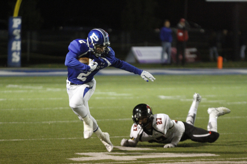       .         ROBERT  K. YOSAY | THE VINDICATOR..Polands #2  Anthon Calcagni breaks away from the grasp of  Canfields #27 Paul French as he goes for big yardage during second quarter action..Canfield at Poland Canfied wins 7-6..-30-
