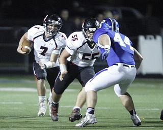       .         ROBERT  K. YOSAY | THE VINDICATOR..Canfields #7 Jake Cummings heads for a first down as team mate #55 Jaret Bunch  blocks #44 Pad O'Saughnessy....Canfield at Poland Canfied wins 7-6..-30-