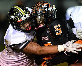 HOWLAND, OHIO - OCTOBER 30, 2015: Tyriq Ellis #5 of Howland is tackled by Kaleb Jones #55 of Harding during the 1st half of their game Friday night at Howland High School. DAVID DERMER | THE VINDICATOR