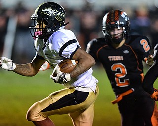 HOWLAND, OHIO - OCTOBER 30, 2015: Lynn Bowden #6 of Harding runs away from George Beatty-Marsh #2 of Howland on his way to scoring the first Harding touchdown of the game during the 1st half of a game Friday night at Howland High School. DAVID DERMER | THE VINDICATOR.