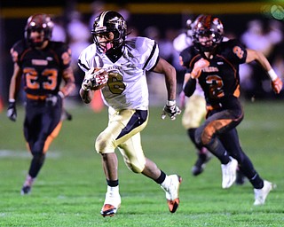 HOWLAND, OHIO - OCTOBER 30, 2015: Lynn Bowden #6 of Harding runs away from Steve Baugh #23 and George Beatty-Marsh #2 of Howland on his way to the end zone to score a Harding touchdown during the 1st half of a game Friday night at Howland High School. DAVID DERMER | THE VINDICATOR.