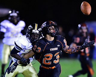 HOWLAND, OHIO - OCTOBER 30, 2015: Steve Baugh #23 of Howland reaches for the deflected ball while being held by Jalen Hooks #22 of Harding during the 1st half of a game Friday night at Howland High School. DAVID DERMER | THE VINDICATOR..The pass would fall incomplete and bring up 4th down.