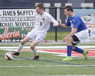 Katie Rickman | The Vindicator.Canfield's  RJ Thomas(#3) keeps moves up the field during the first half as Poland's Evan Rumble (#16) attempts to block him during the game in Niles on Saturday night.